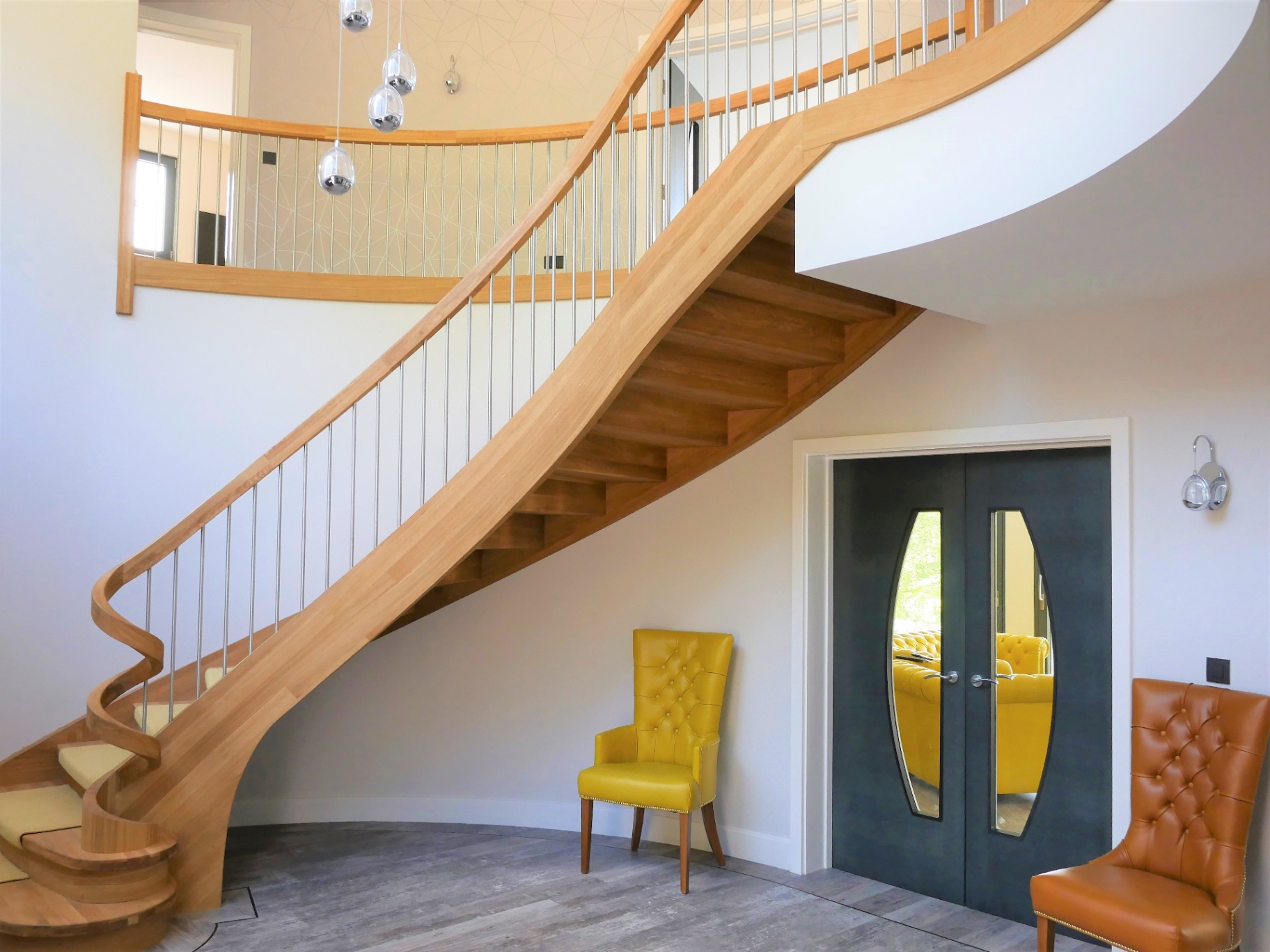 Sculptural curved oak staircase inside a Worcester Lloyd new build home