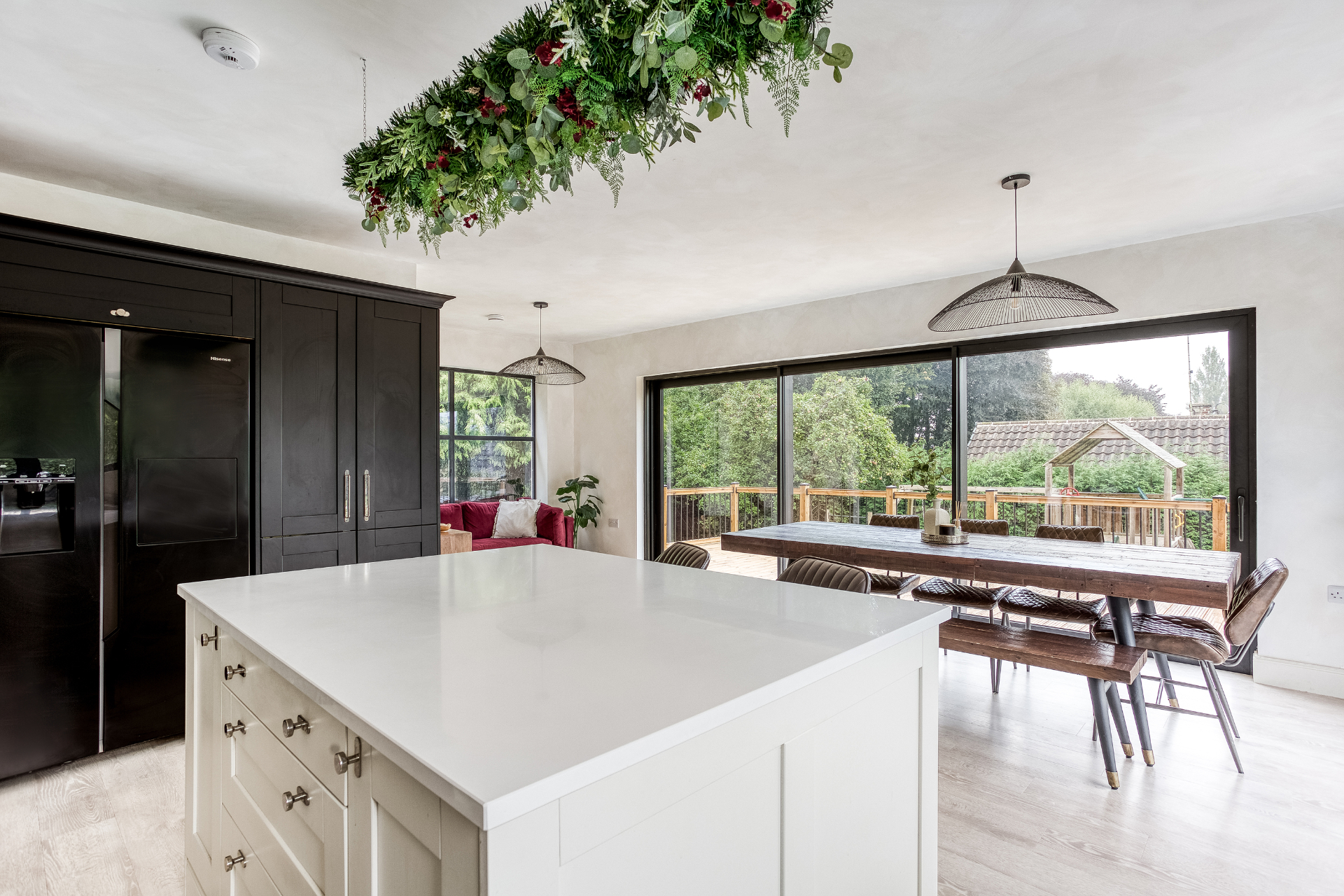 Open-plan kitchen extension in Derbyshire with island, bi-fold doors and garden views